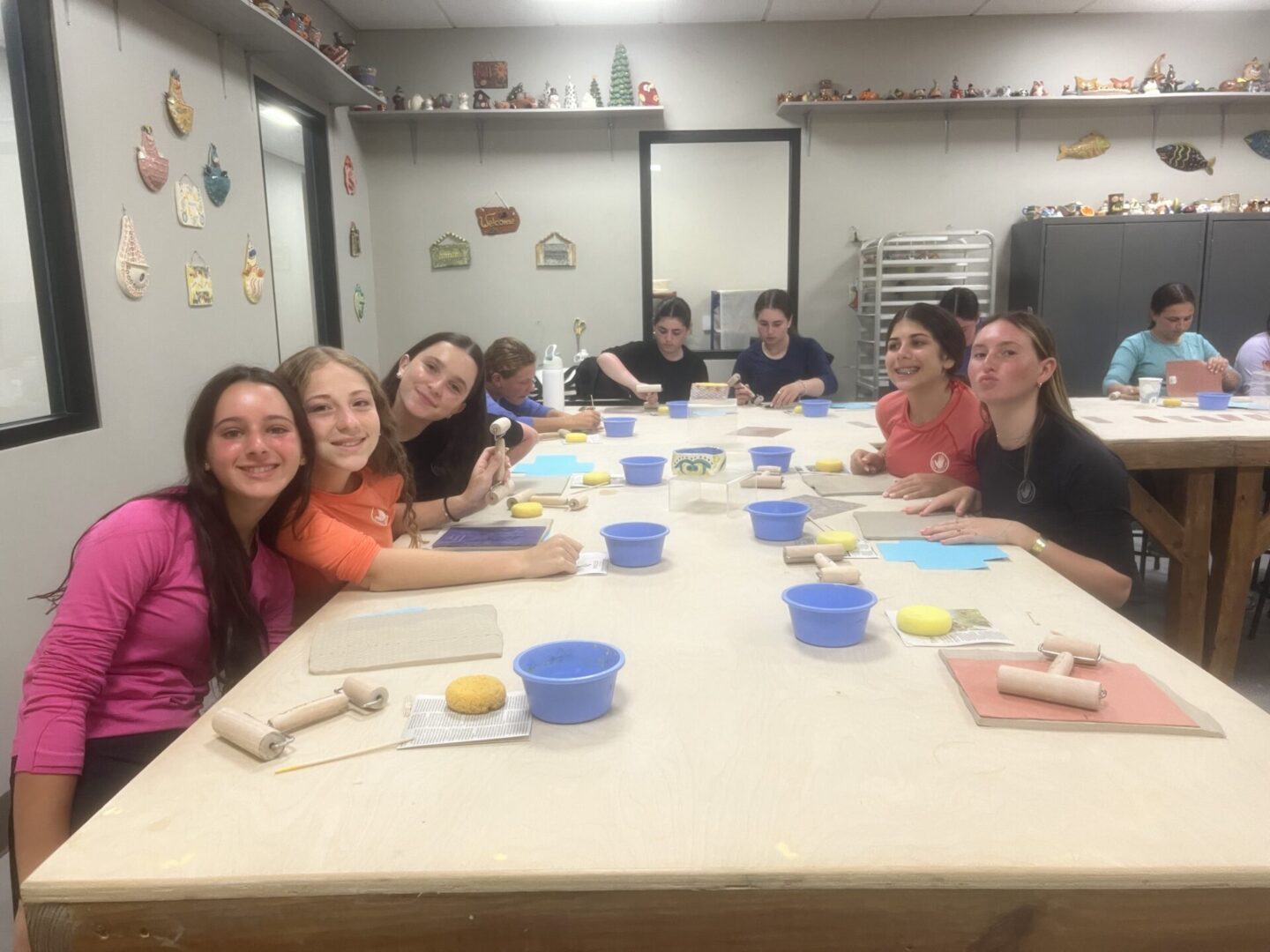 A group of people gathered around a table for a baking or crafting activity.