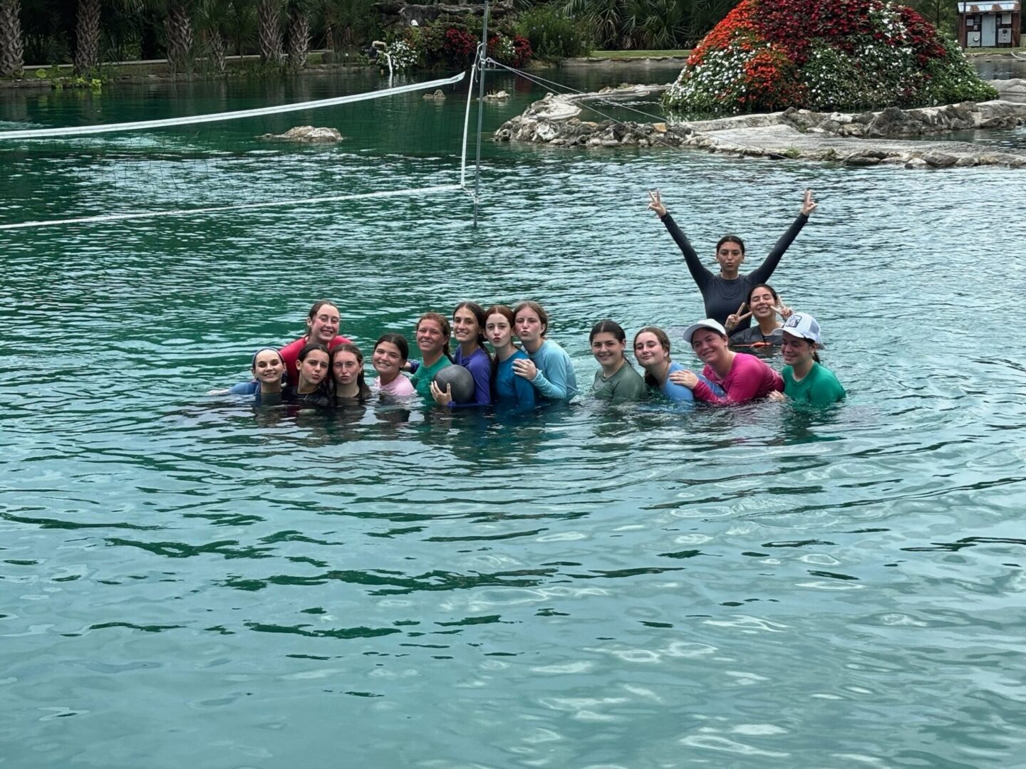 A group of people enjoying time together in a natural water pool.