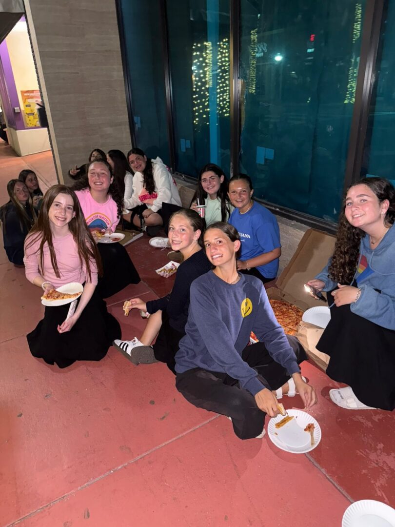 A group of friends enjoying a meal together at night.
